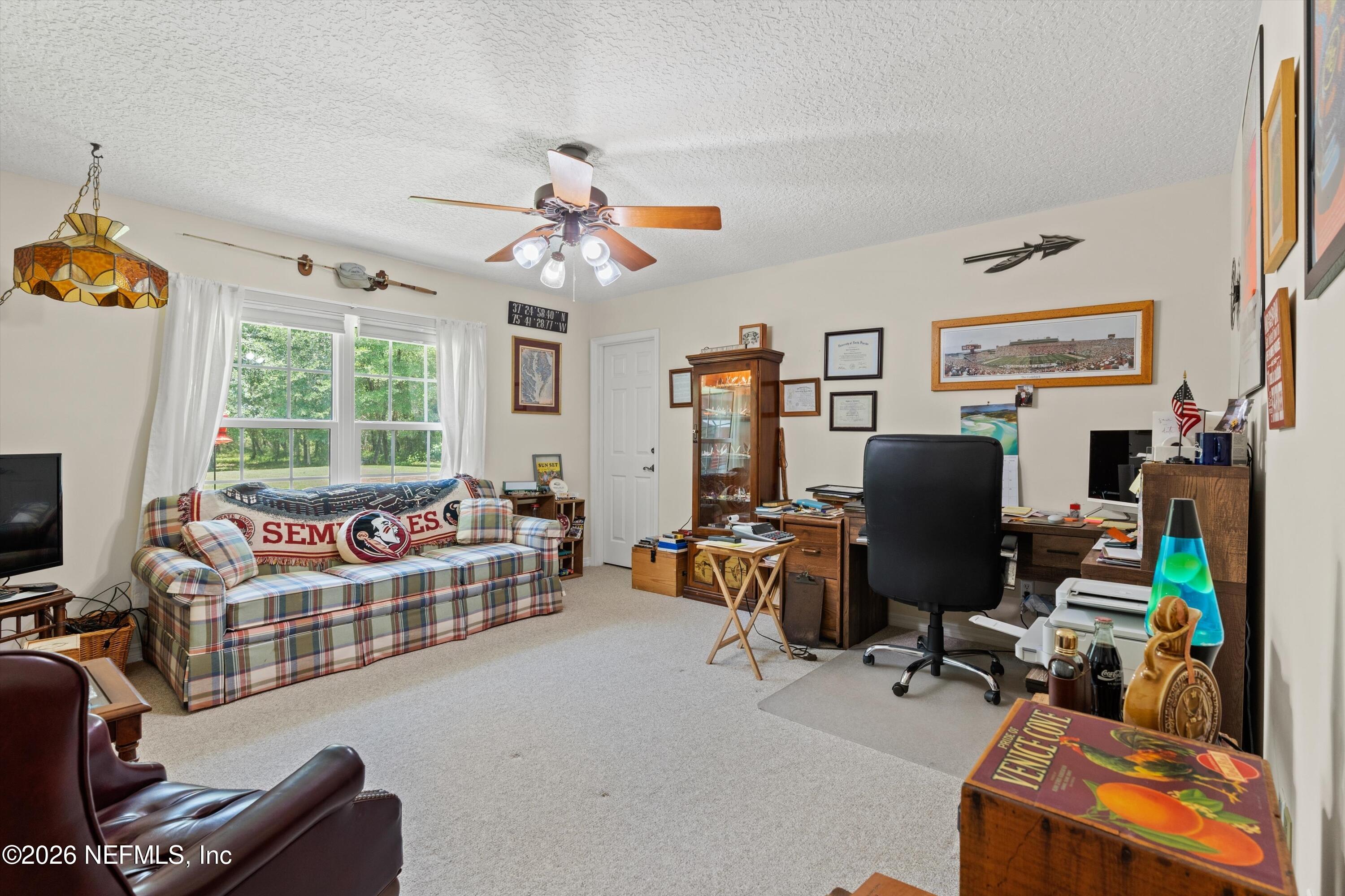 5566 Don Manuel Road Elkton, FL 32033 - Photo 28 of 47 a living room with furniture a flat screen tv and a window