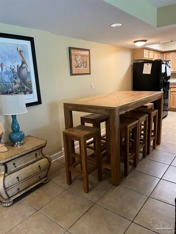 a kitchen with stainless steel appliances kitchen island granite countertop a table and chairs