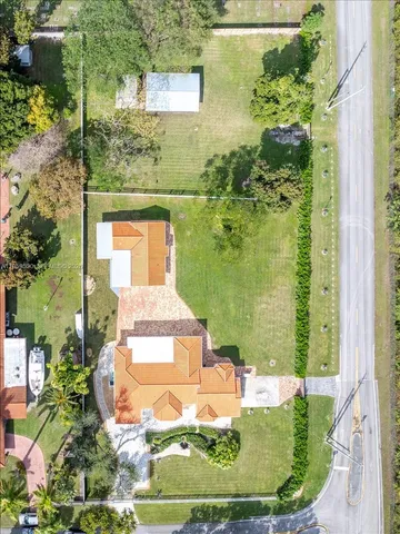 an aerial view of a residential houses with outdoor space and street view