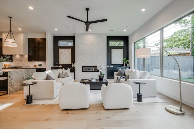 wooden floor in an empty room with a chandelier fan