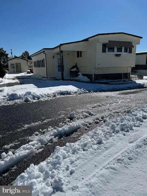 9916 Golf Course Road, Unit 61 Ocean City, MD 21842 - Photo 3 of 18 a view of a blue house with a yard