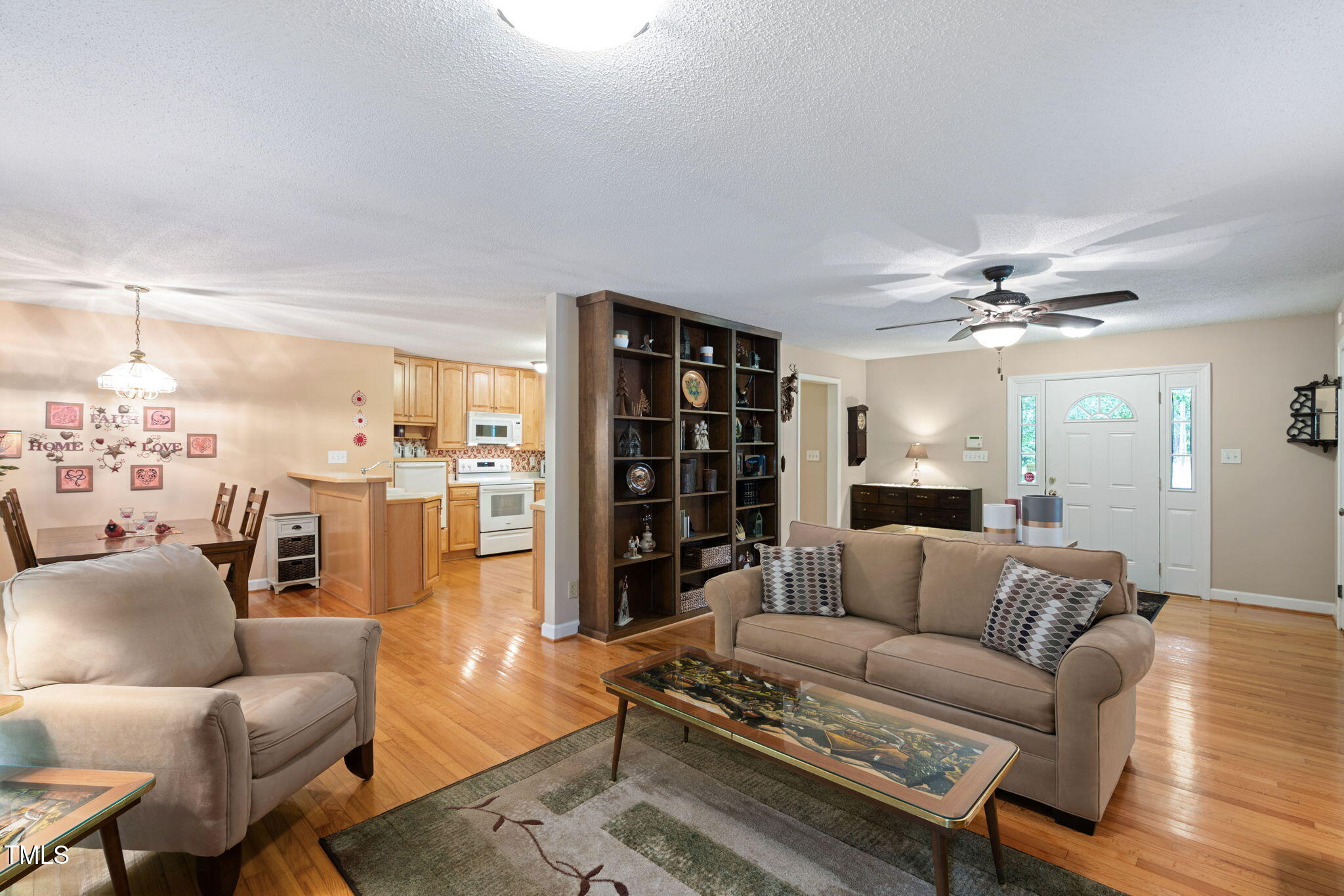 8236 Jackson Road Wake Forest, NC 27587 - Photo 12 of 74 a living room with furniture ceiling fan and a rug