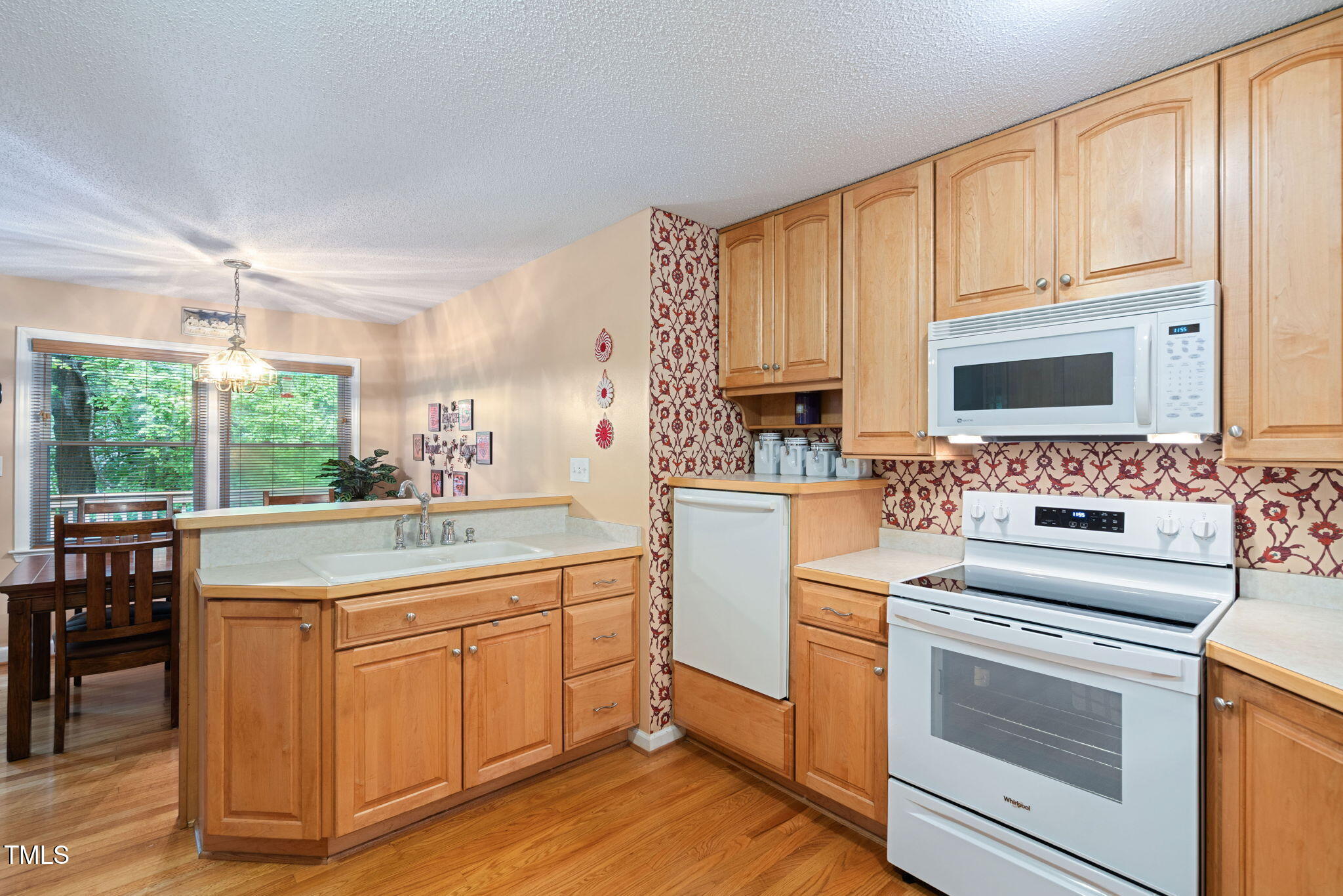 8236 Jackson Road Wake Forest, NC 27587 - Photo 16 of 74 a kitchen with a stove a sink and white cabinets