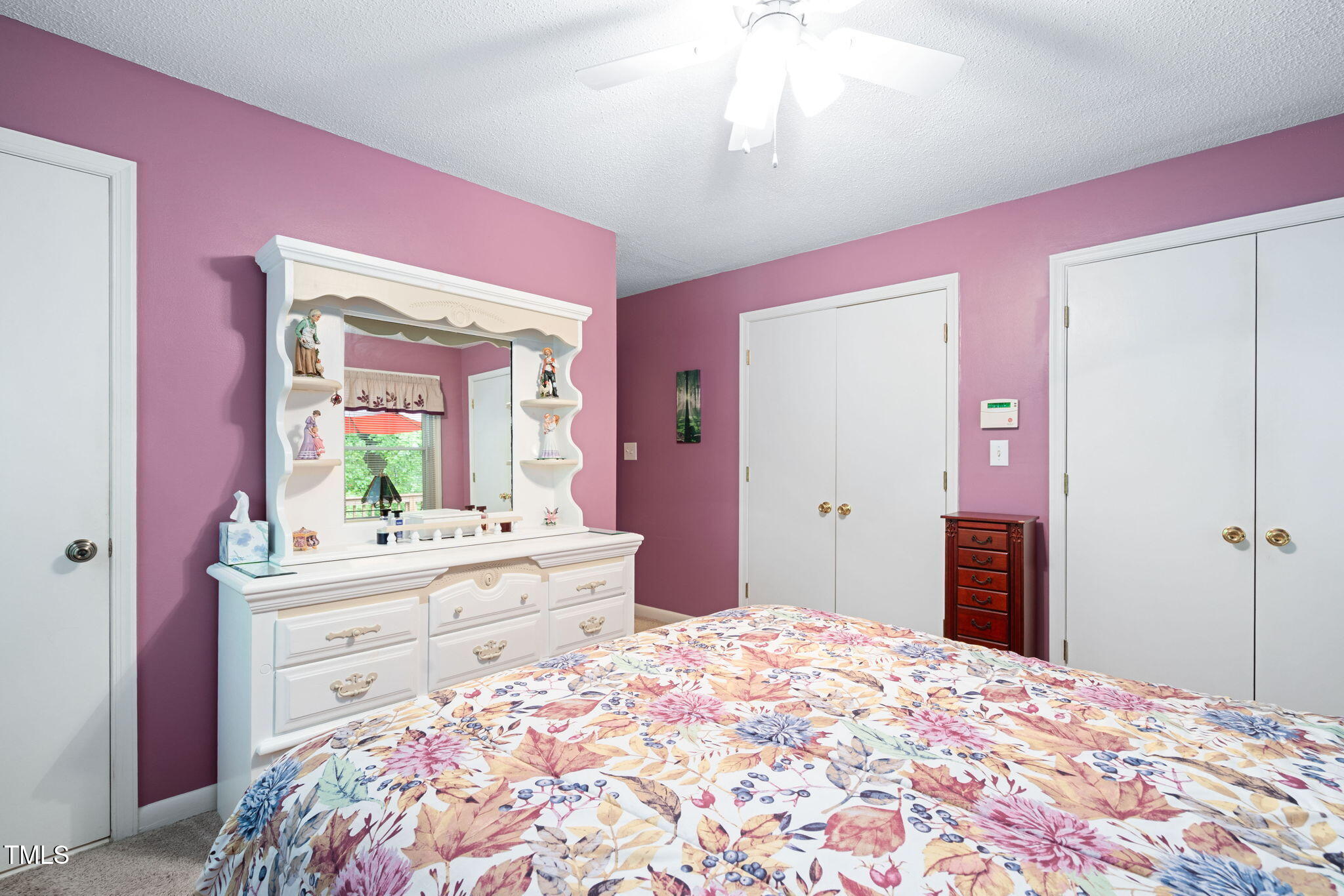 8236 Jackson Road Wake Forest, NC 27587 - Photo 25 of 74 a bedroom with a bed and a mirror on dresser