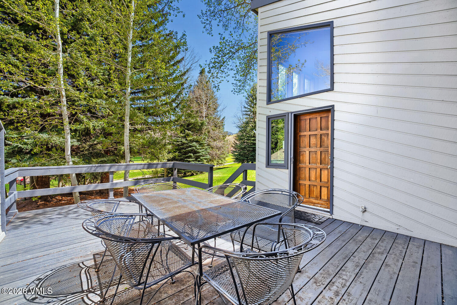 128 Beaver Road, Unit EAST Eagle-Vail, CO 81620 - Photo 20 of 21 a view of a chairs with a table and chairs on wooden deck