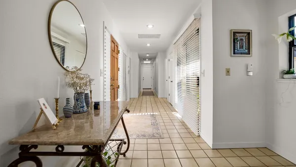 a view of an entryway with wooden floor and a rug