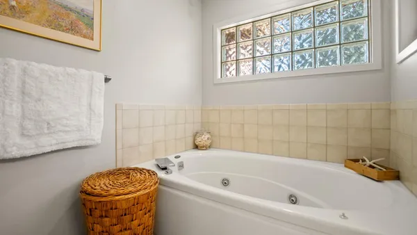 a bathroom with a tub and a window
