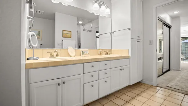a bathroom with a double vanity sink mirror and double