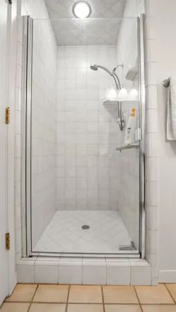 a bathroom with a glass shower door