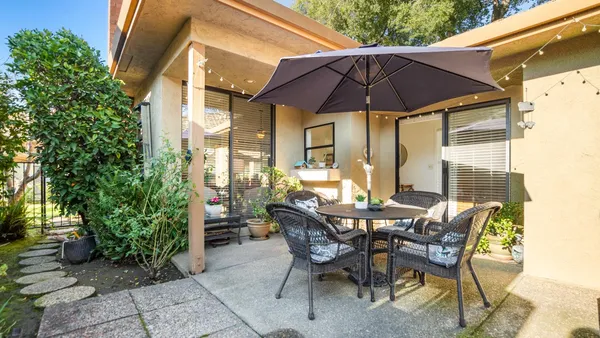 a view of an outdoor space with furniture and umbrella