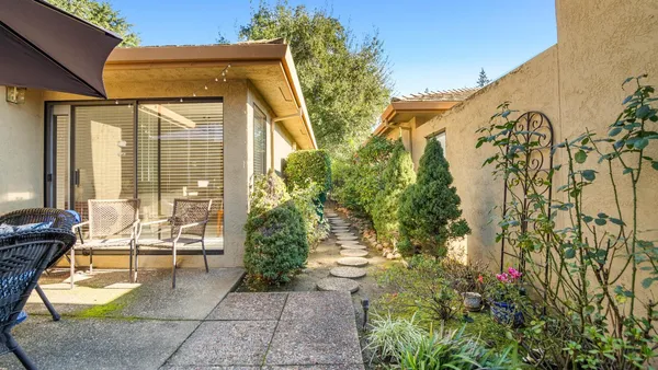 a view of a house with sitting area and garden