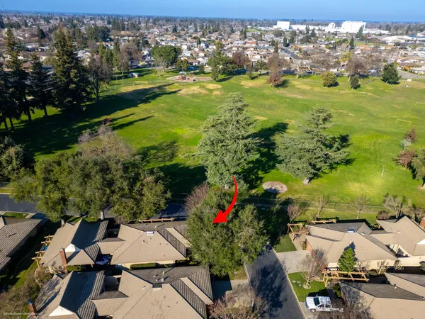 an aerial view of residential houses with outdoor space