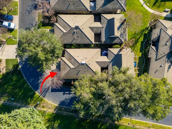an aerial view of a house with swimming pool and garden