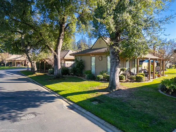 a view of a house with yard and tree s