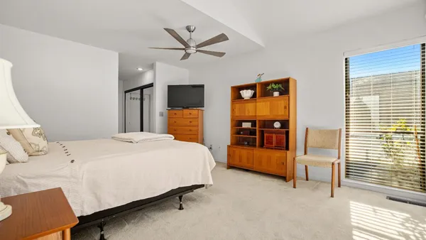 a bedroom with a bed and a flat tv screen