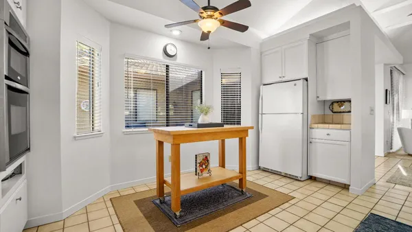 a view of a hallway with closet and a window