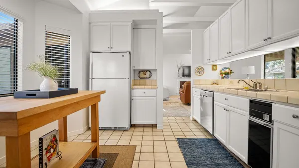 a kitchen with stainless steel appliances a refrigerator sink and cabinets