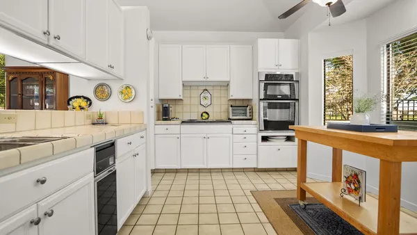 a kitchen with stainless steel appliances a stove a sink and a refrigerator