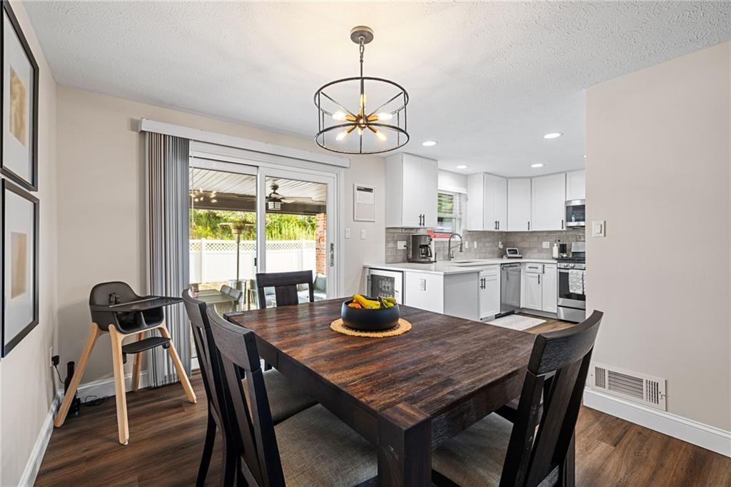 75 Fawnvue Drive McKees Rocks, PA 15136 - Photo 13 of 46 a kitchen with a dining table chairs and wooden floor