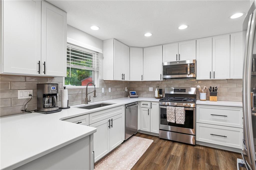 75 Fawnvue Drive McKees Rocks, PA 15136 - Photo 17 of 46 a kitchen with stainless steel appliances a sink a stove a refrigerator cabinets and a window