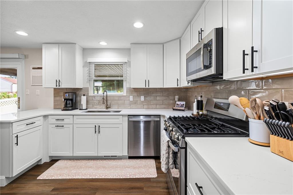 75 Fawnvue Drive McKees Rocks, PA 15136 - Photo 18 of 46 a kitchen with stainless steel appliances granite countertop a stove a sink and white cabinets