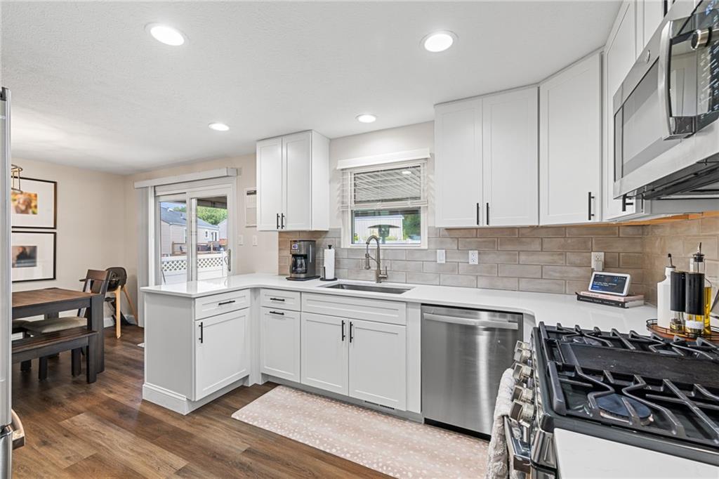 75 Fawnvue Drive McKees Rocks, PA 15136 - Photo 20 of 46 a kitchen with a sink white cabinets and appliances