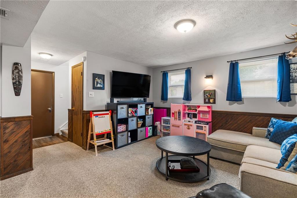 75 Fawnvue Drive McKees Rocks, PA 15136 - Photo 32 of 46 a living room with furniture and a flat screen tv
