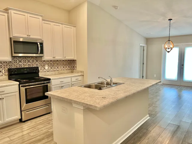a kitchen with a sink stove and microwave