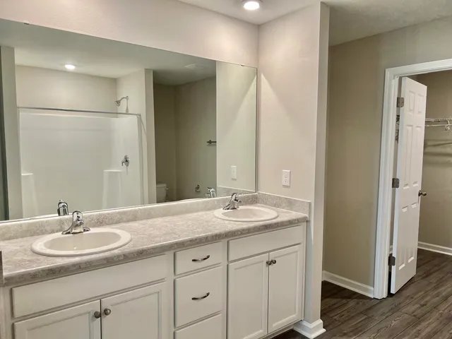 a bathroom with a sink double vanity and a mirror