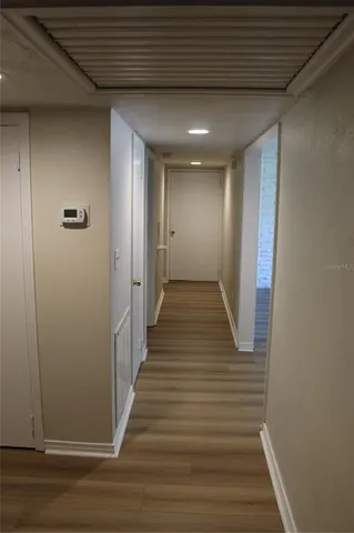 a view of a hallway with wooden floor