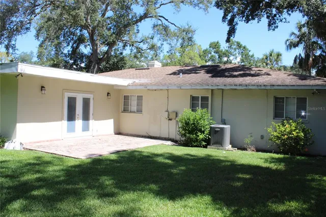 a view of a house with a yard and a garden