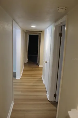 a view of a hallway with wooden floor