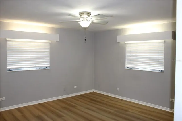 a view of a room with a ceiling fan and a window