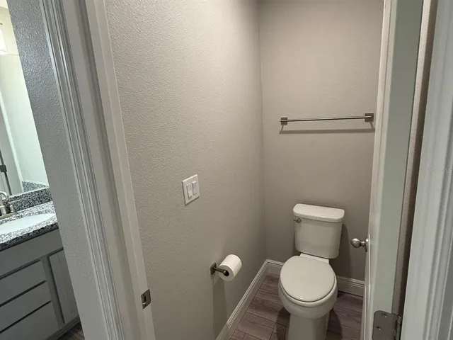 a white toilet sitting next to a sink