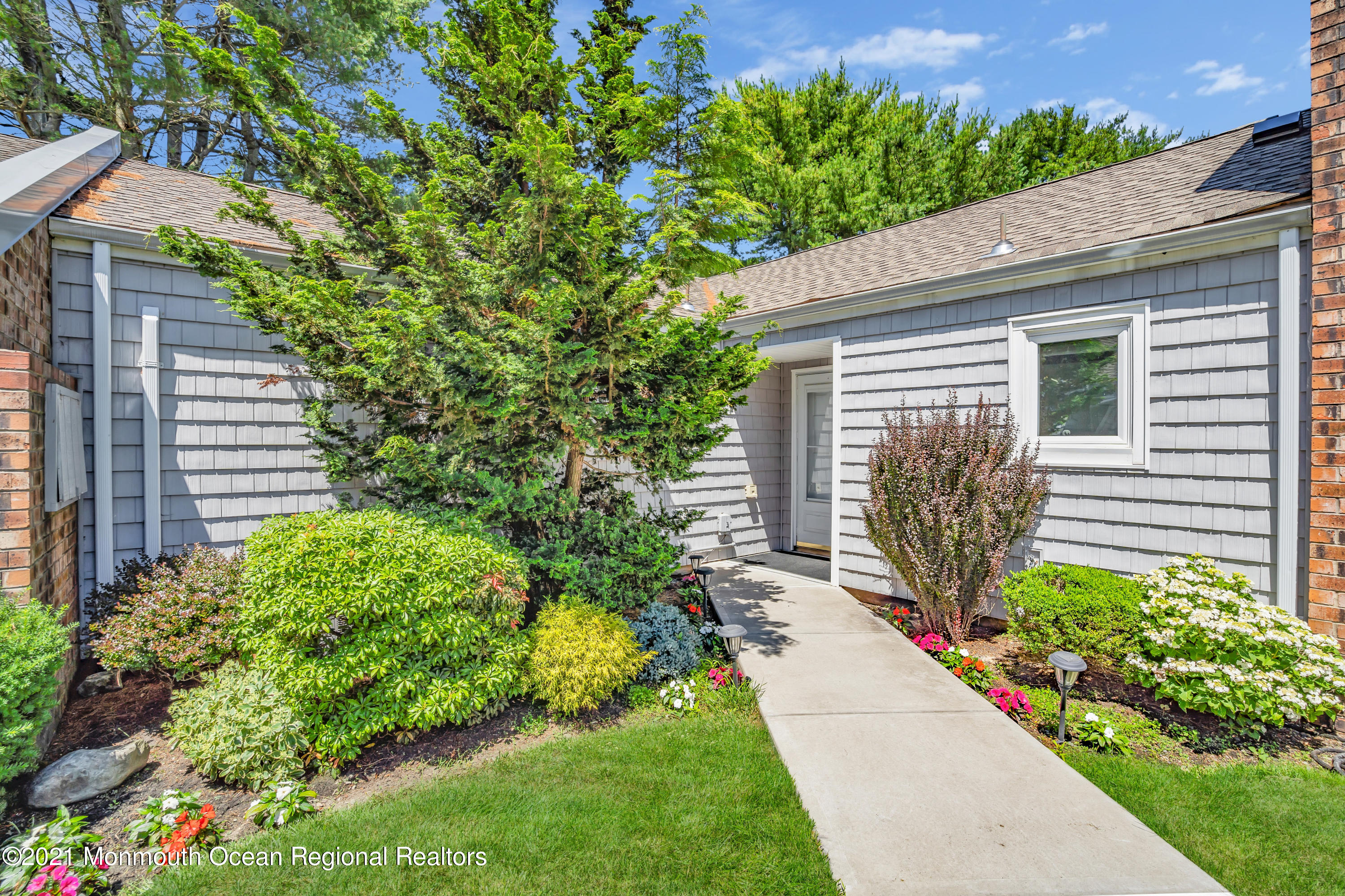 27 Locust Way Spring Lake Heights, NJ 07762 - Photo 1 of 43 a backyard of a house with a garden