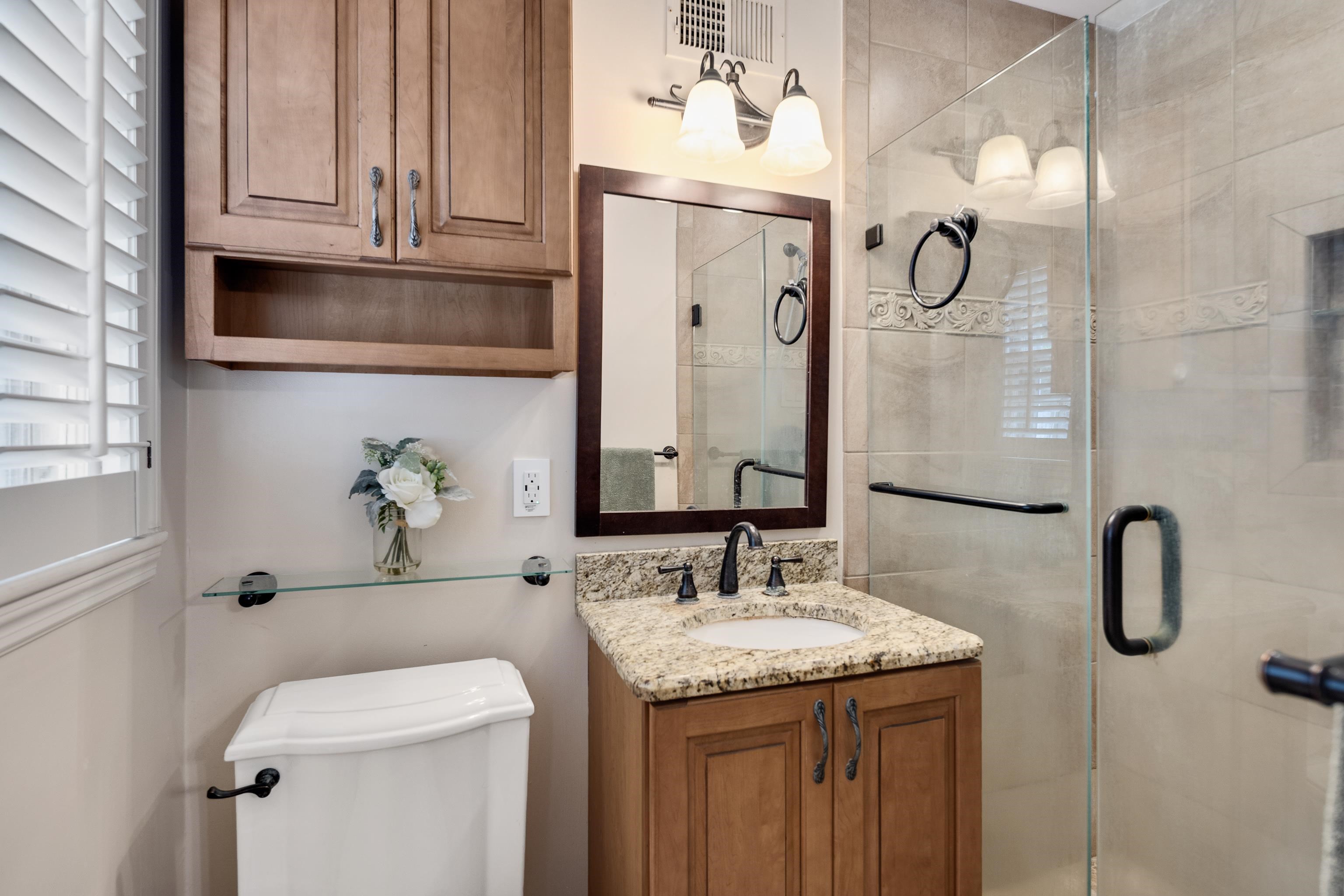 4474 Cherrydale Road Memphis, TN 38117 - Photo 18 of 35 a bathroom with a granite countertop sink and a mirror