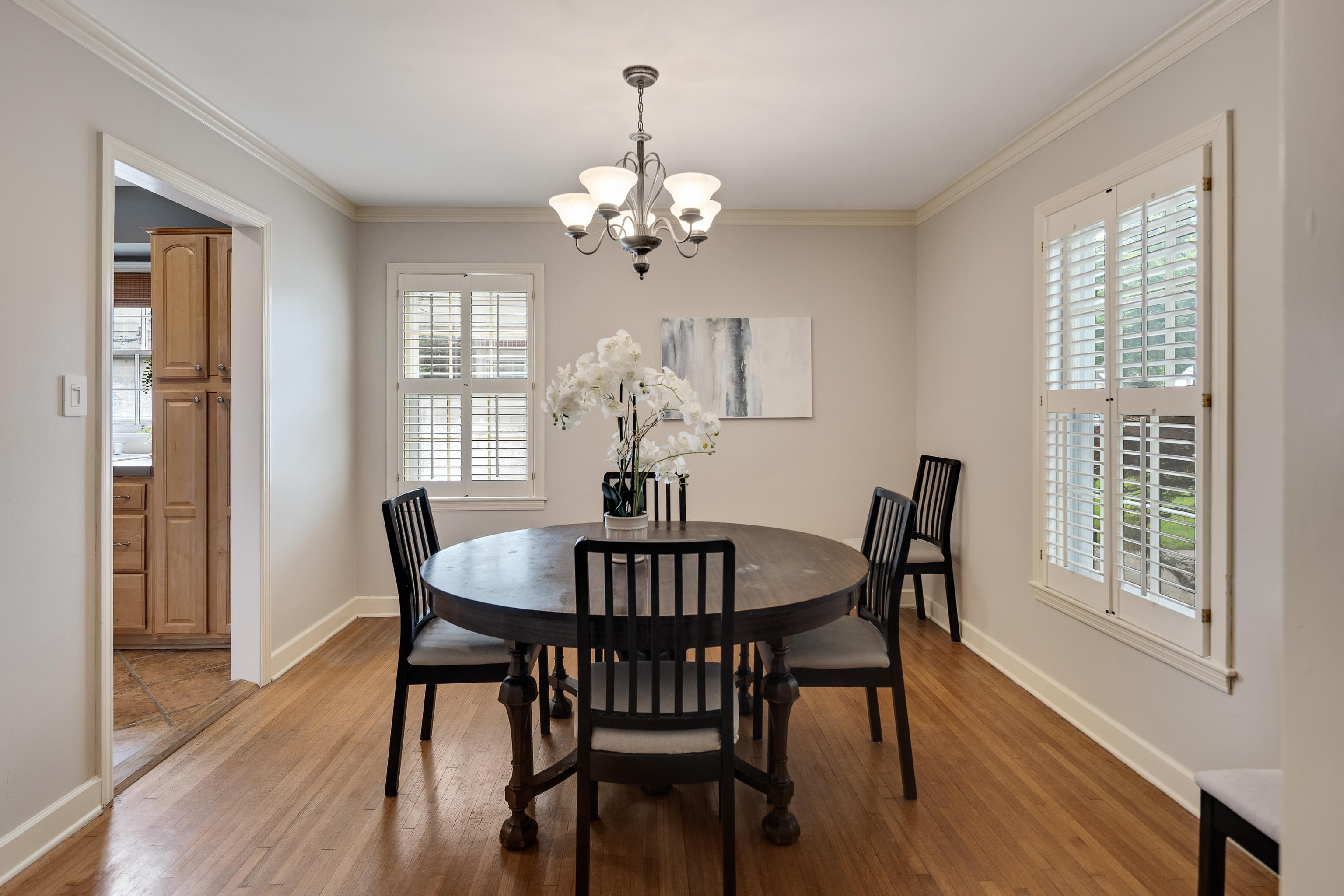 4474 Cherrydale Road Memphis, TN 38117 - Photo 5 of 35 a view of a dining room with furniture a chandelier and wooden floor