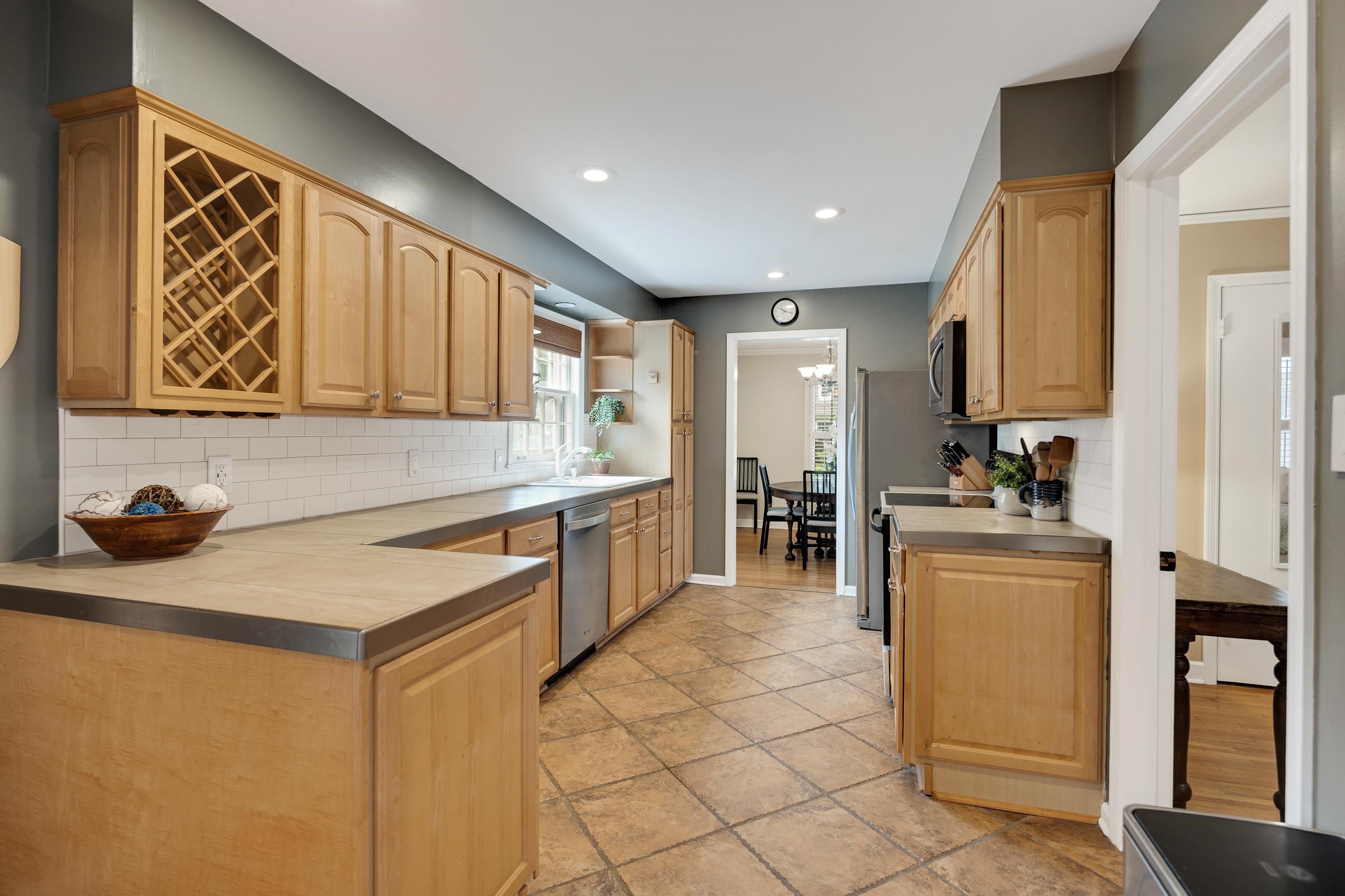 4474 Cherrydale Road Memphis, TN 38117 - Photo 8 of 35 a kitchen with stainless steel appliances granite countertop a stove a sink and a microwave