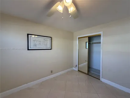 a kitchen with a refrigerator and a stove top oven