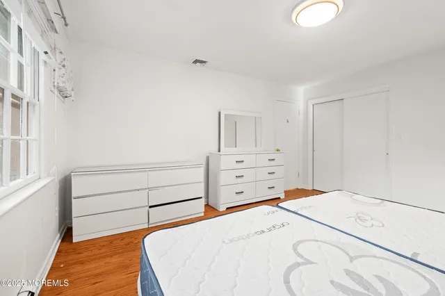 a bedroom with a bed and cabinet
