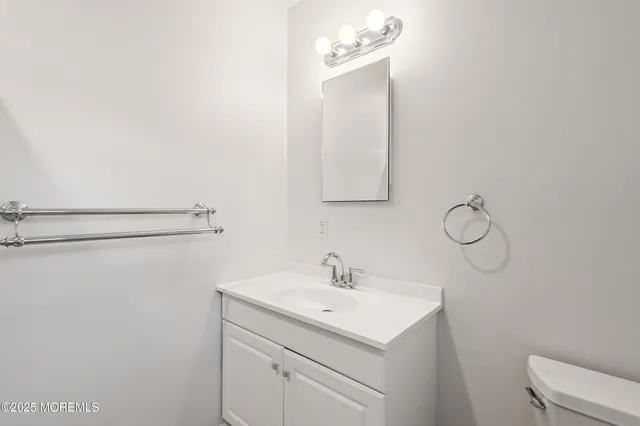 a bathroom with a sink vanity and mirror