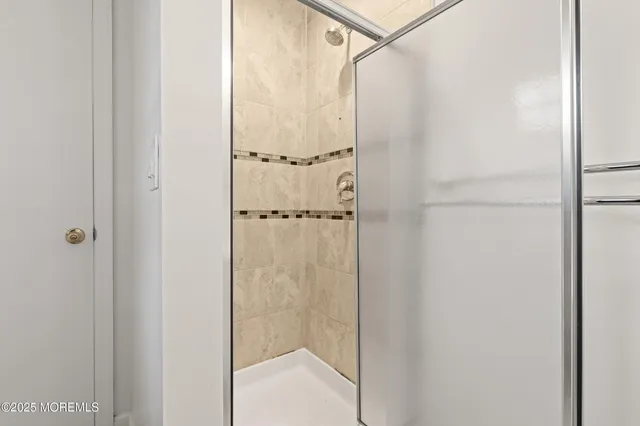 a bathroom with a glass shower door