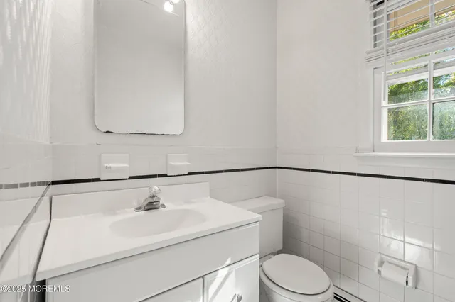 a bathroom with a sink toilet and vanity