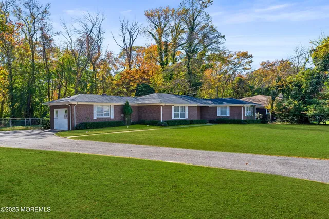 a view of a big yard with a house in the background