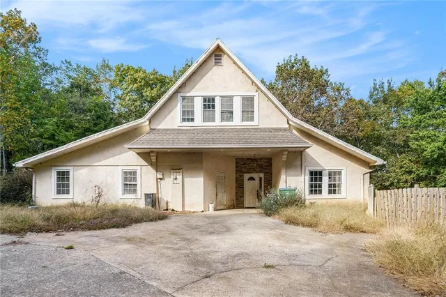 a front view of a house with a garden
