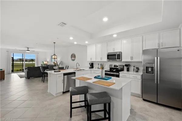 a kitchen with a refrigerator a stove a dining table and chairs