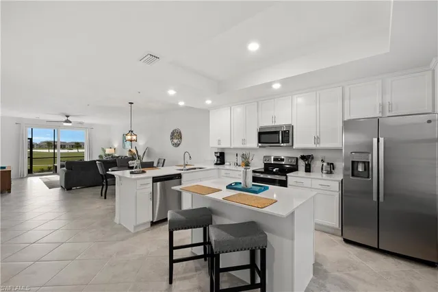 a kitchen with a refrigerator a stove a dining table and chairs