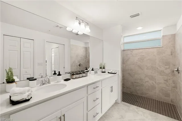 a bathroom with a double vanity sink mirror and double