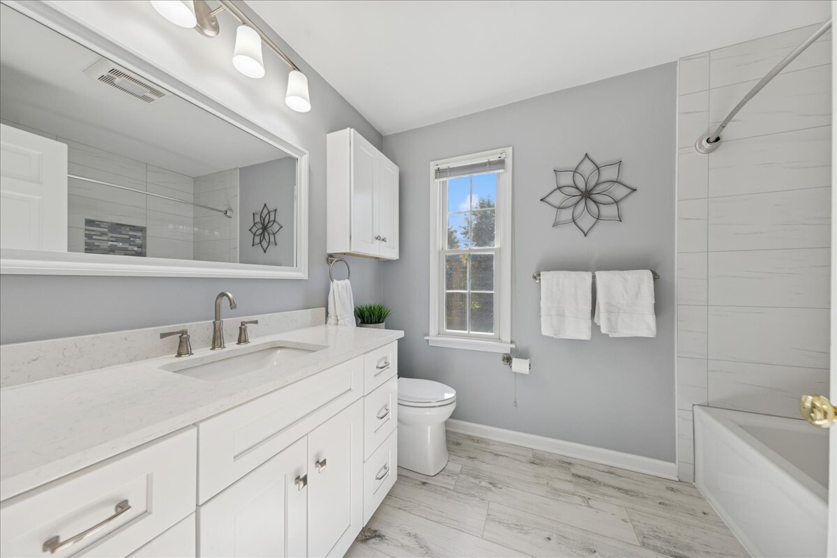 415 Hamilton Drive Wheaton, IL 60189 - Photo 19 of 27 a bathroom with a granite countertop sink mirror vanity and toilet