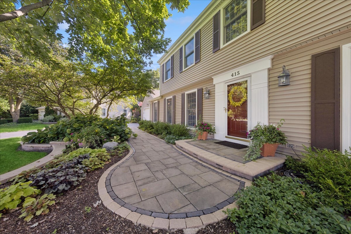 415 Hamilton Drive Wheaton, IL 60189 - Photo 3 of 27 a view of a house with brick walls plants and large tree